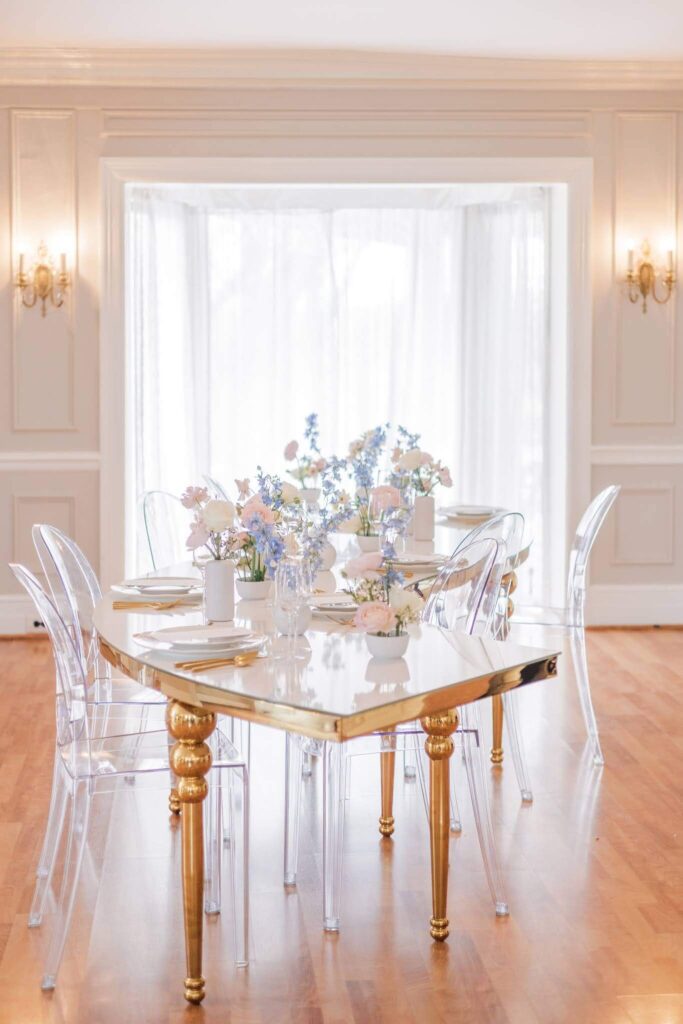 Elegant s-shaped wedding reception table with whimsical pastel flowers