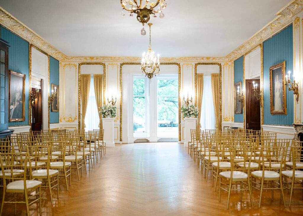 Elegant gilded wedding ceremony setup at the Engineers Club in Baltimore, Maryland