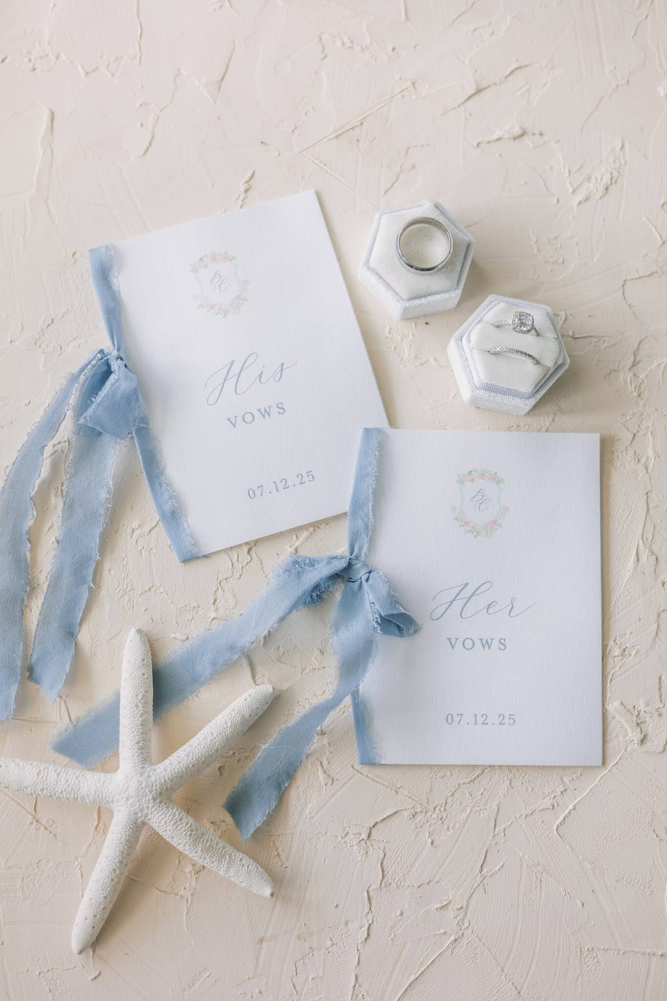 His and hers wedding vow books with silk ribbon and a custom crest