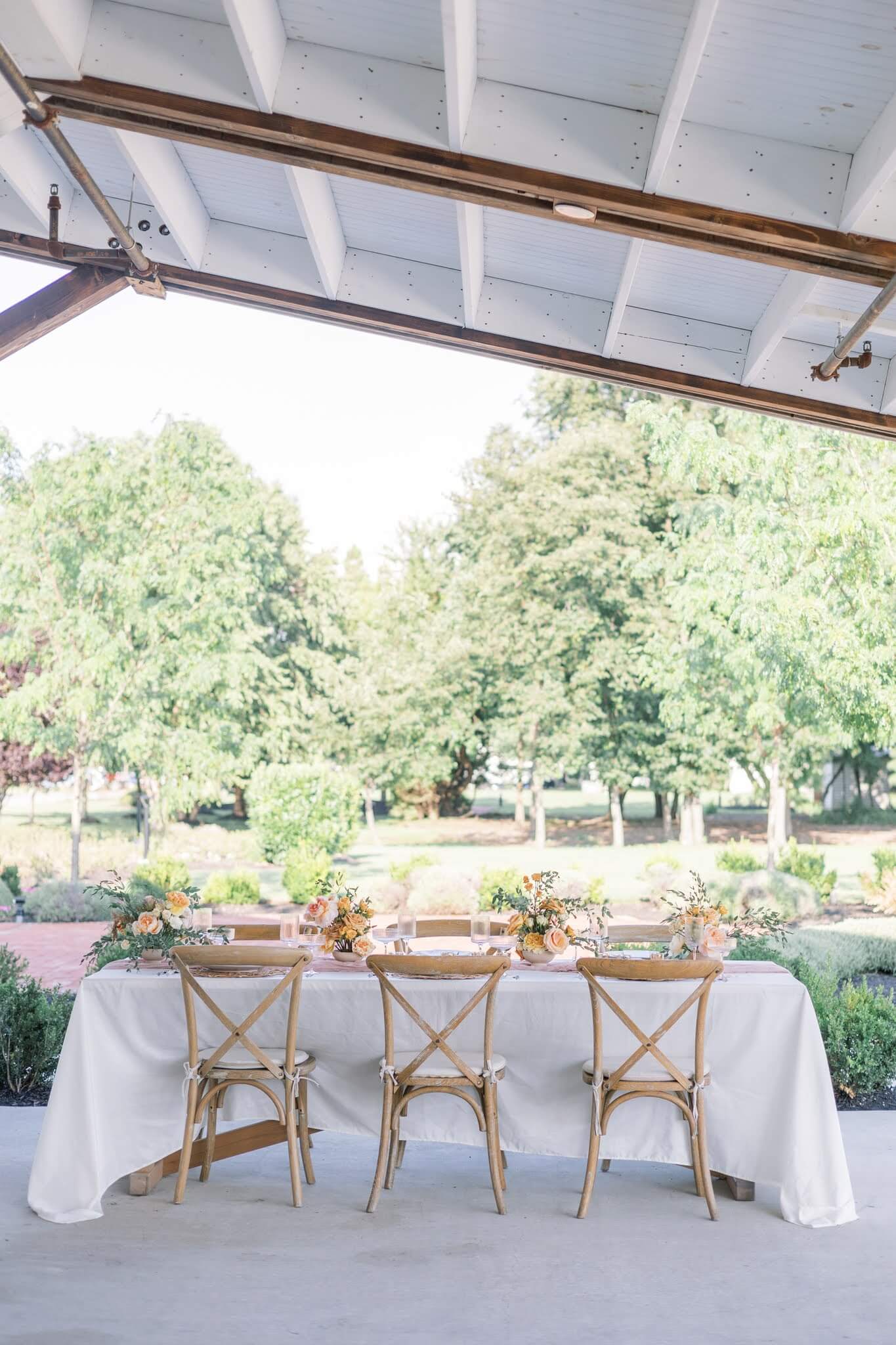 Wedding reception table featuring orange floral centerpieces