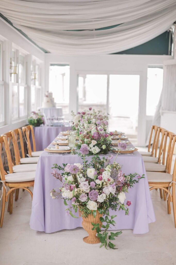 Enchanting lilac wedding reception table set up in a closed-in porch at Overhills Mansion