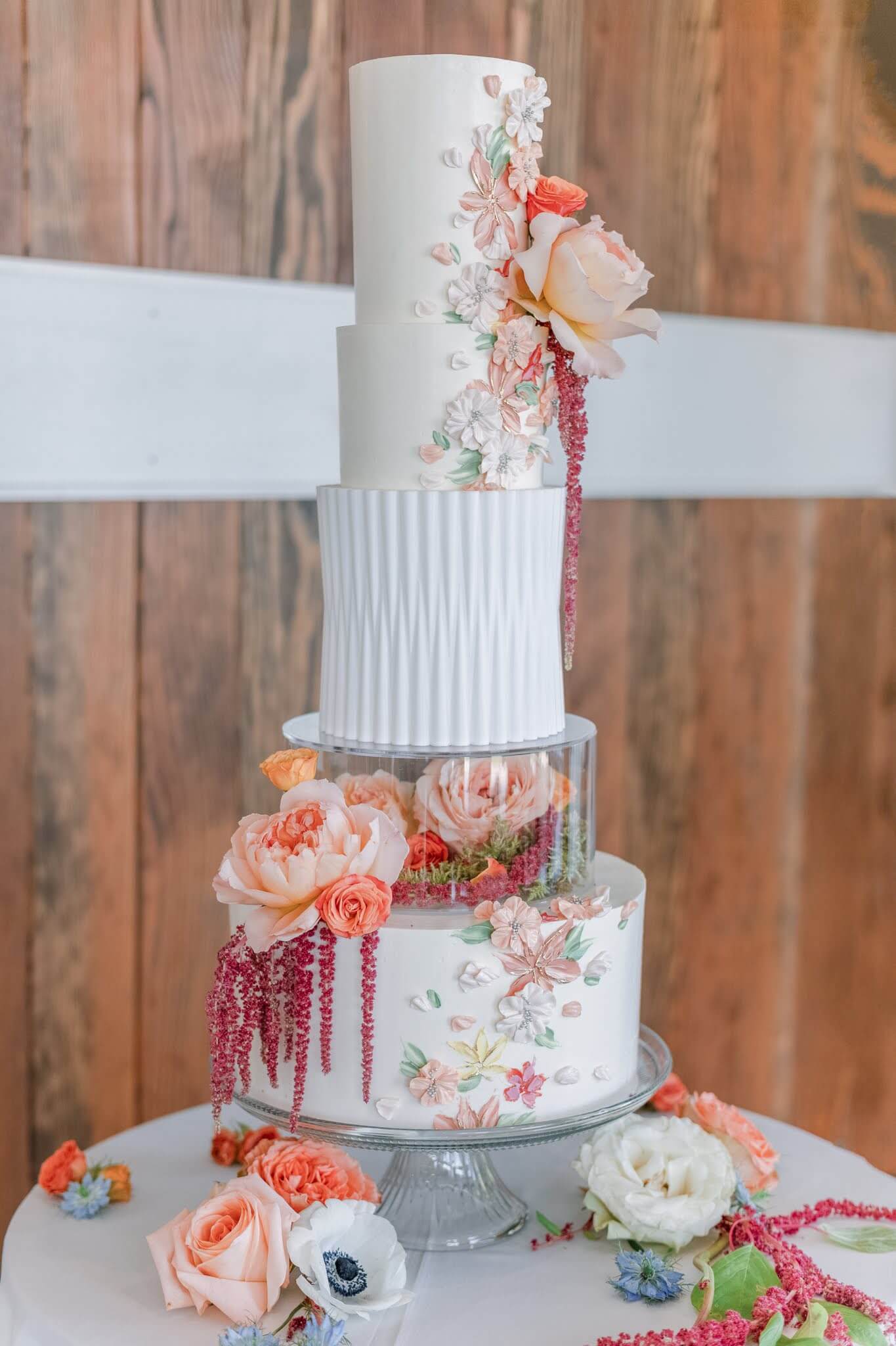 Abstract and artistic five-tier wedding cake with orange floral details