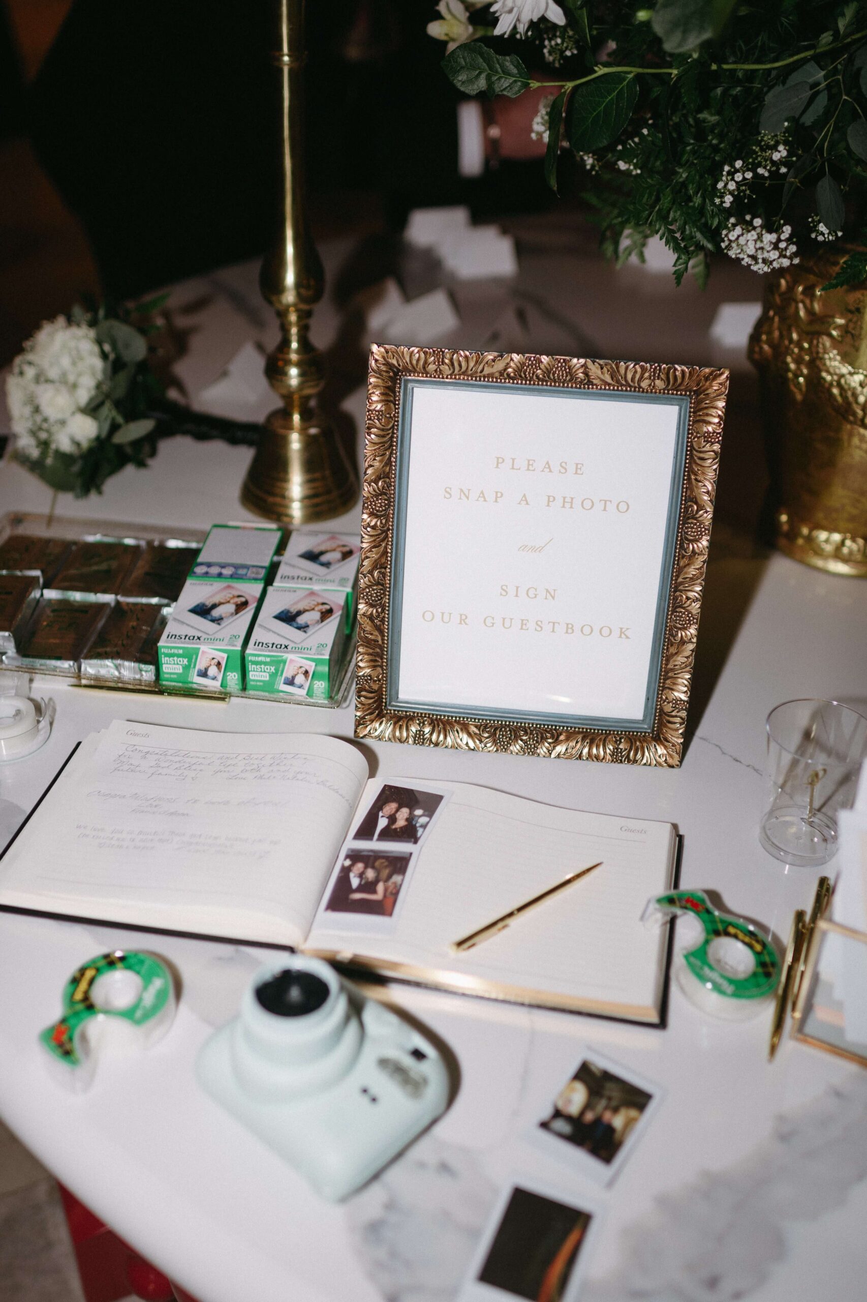 Wedding reception photo guestbook sign in an ornate gold frame