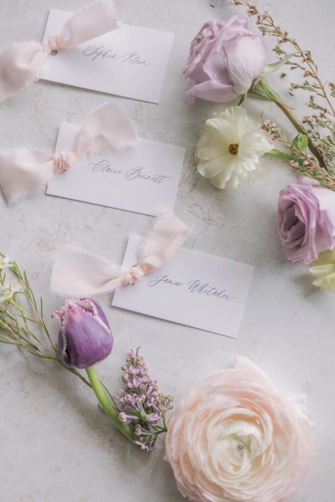 Wedding reception place cards with light pink silk ribbon