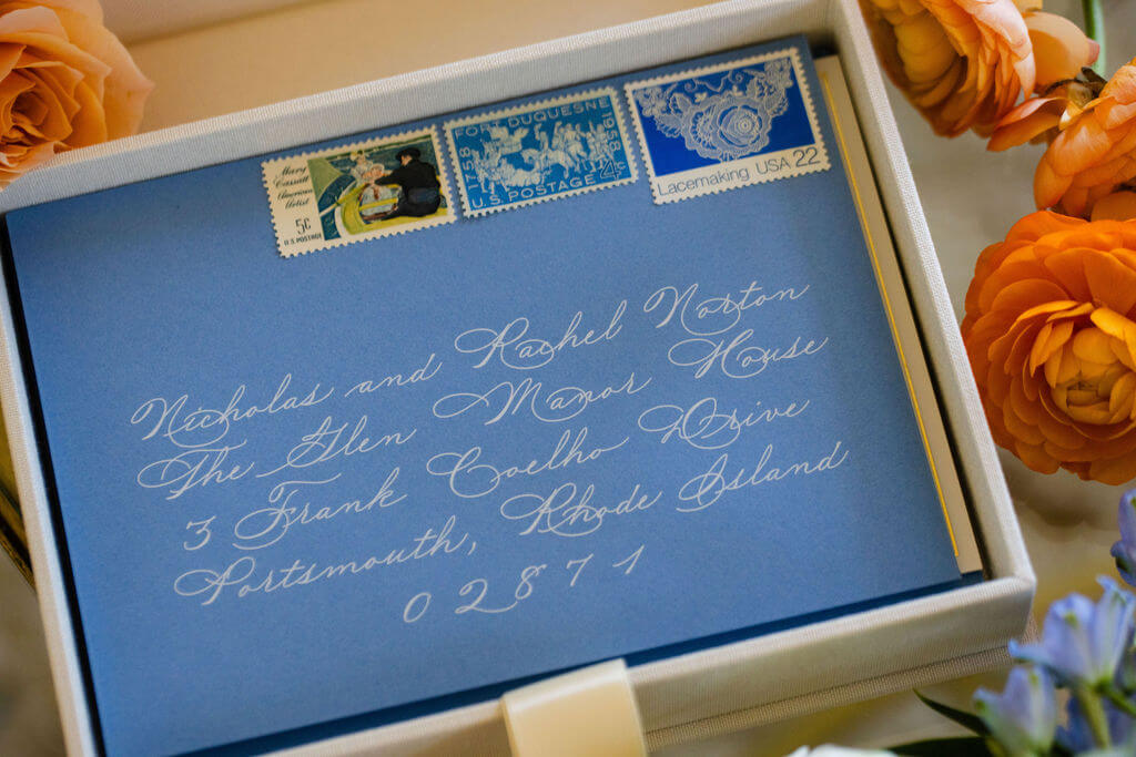 Calligraphed envelope sits atop a wedding invitation keepsake suite