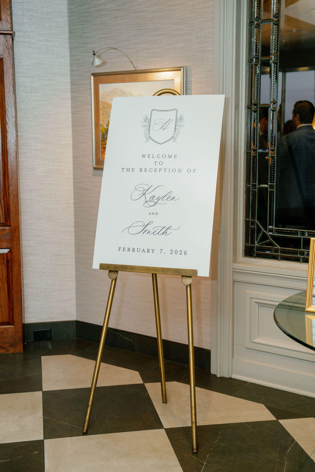 Classic and elegant wedding reception welcome sign displayed on a gold easel