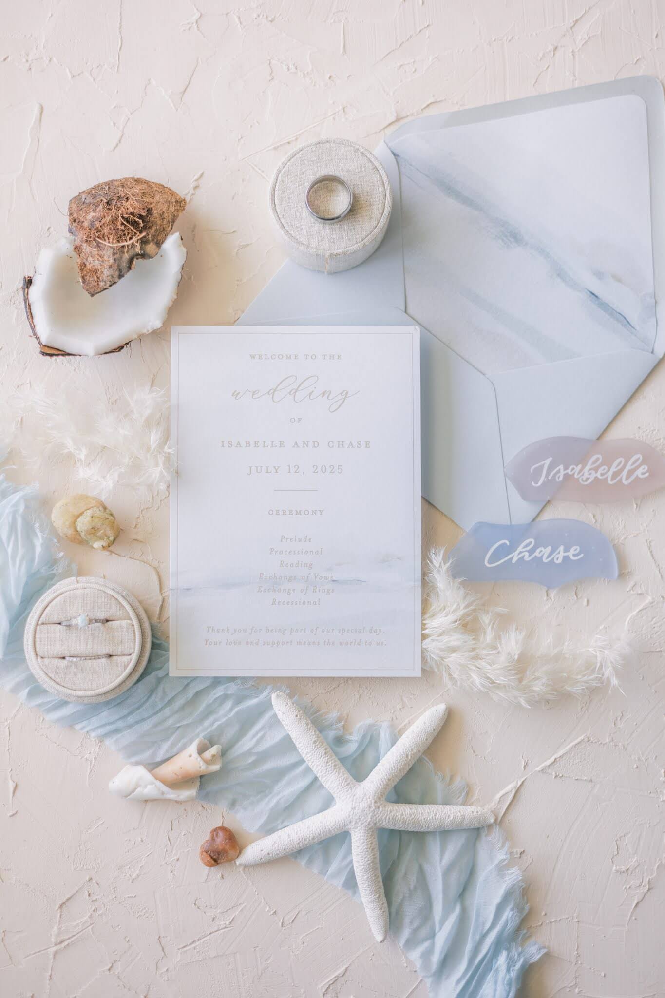 Neutral wedding invitation envelope liner in soft shades of tan, white, and blue