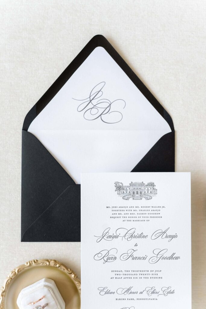 Classic black and white letterpress invitation card with black silk ribbon and monogram envelope liner