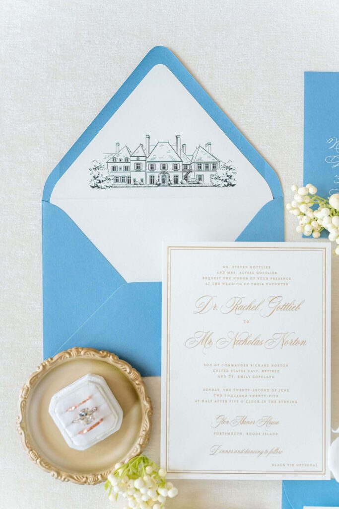 Classic white and gold foil press wedding invitation card with envelope liner featuring line art venue illustration