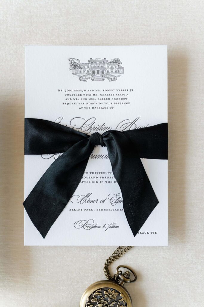 Classic black and white wedding invitation card with black silk ribbon and venue illustration of Elkins Estate