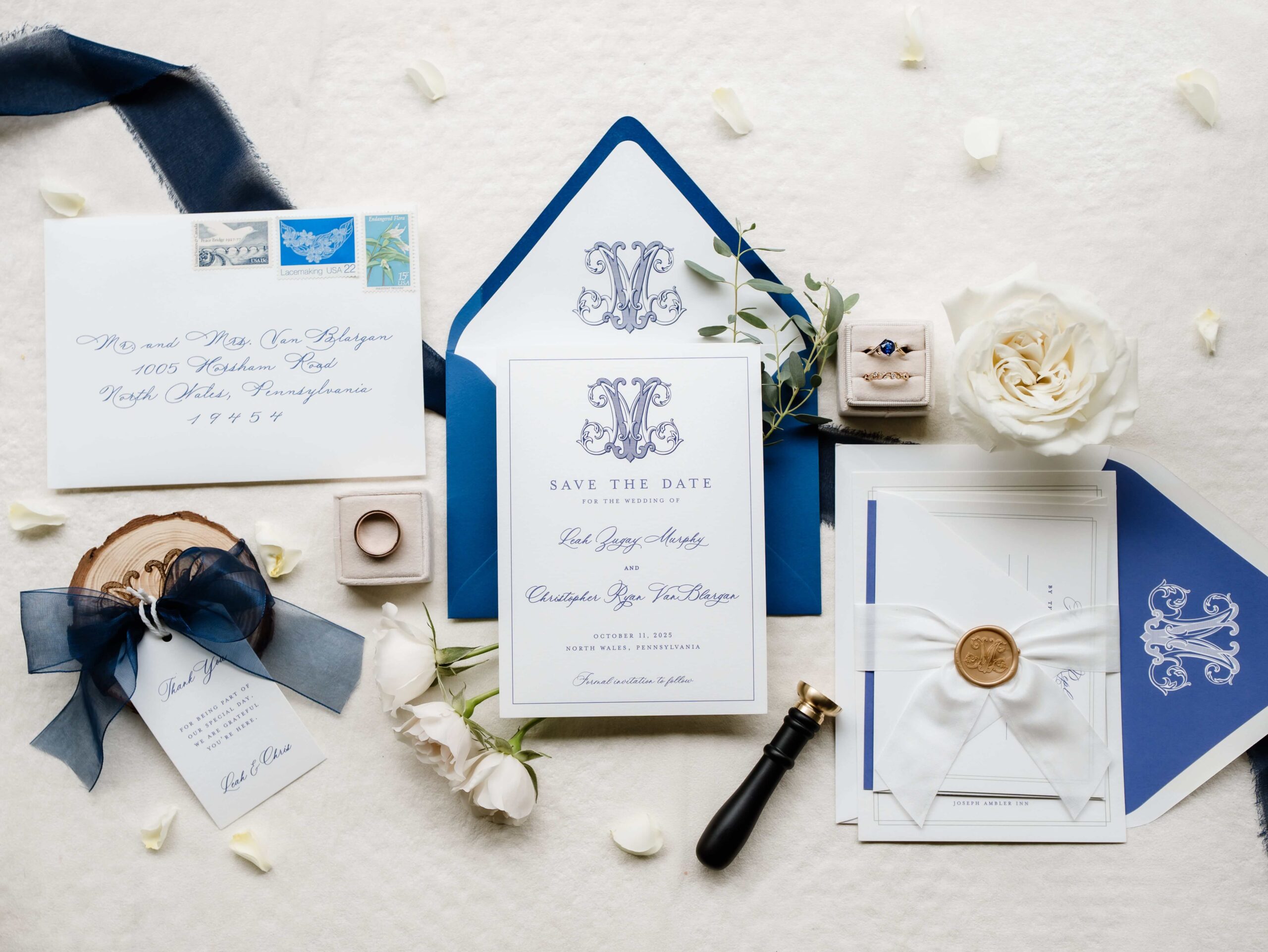 Elegant blue and white save the date card with a custom monogram and blue envelope with monogrammed envelope liner