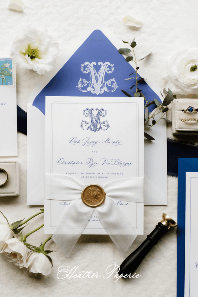 Elegant blue and white wedding invitation card with a custom monogram