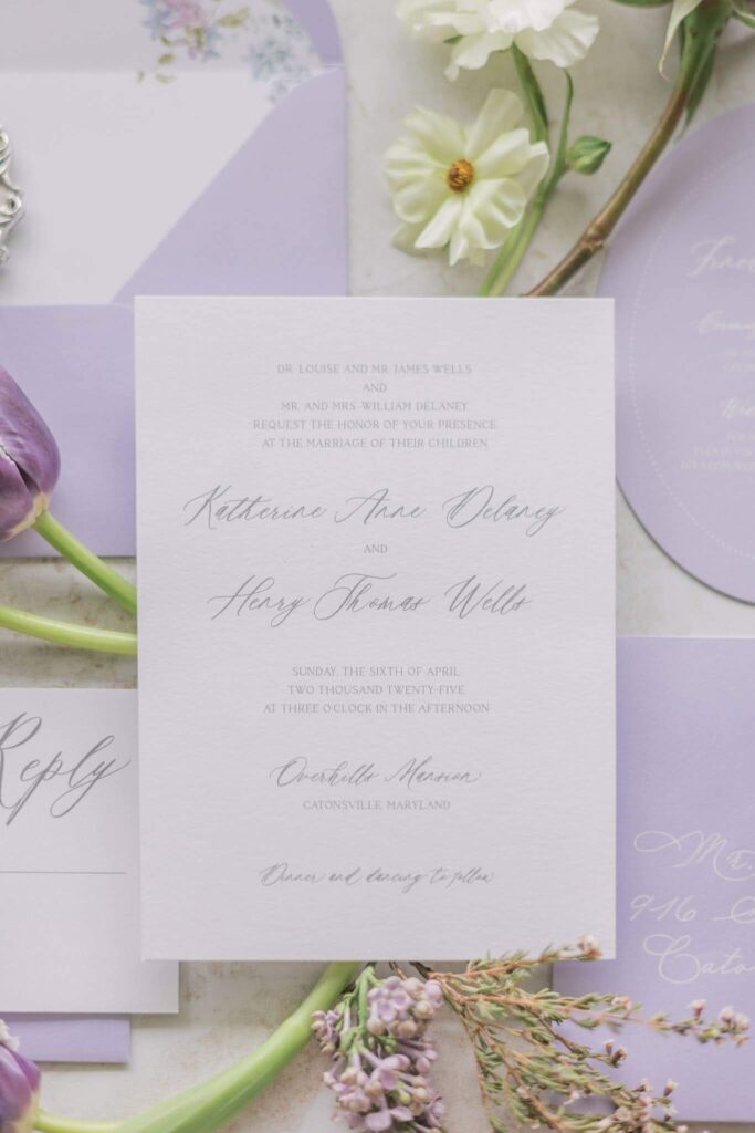 Delicate and romantic wedding invitation card in white and purple