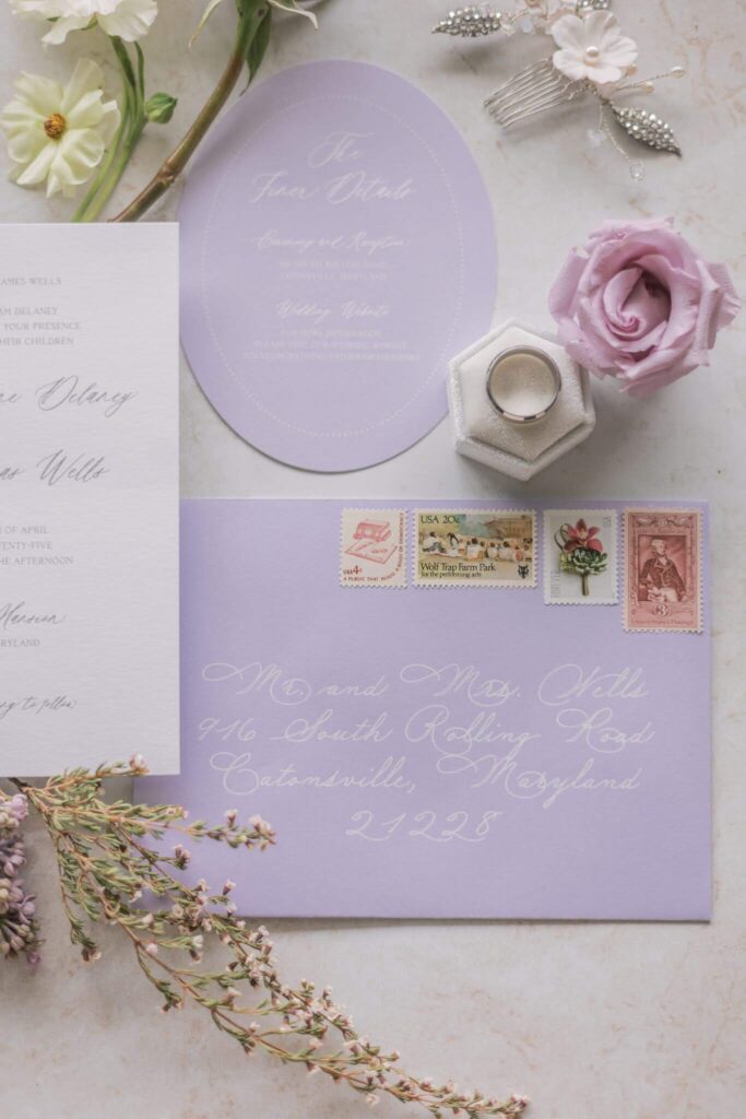 Romantic lilac wedding invitation envelope with calligraphy and vintage postage