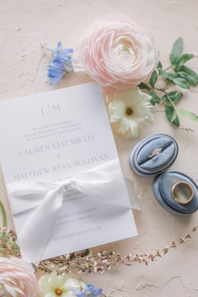 Elegant wedding invitation card enclosed with a white silk ribbon