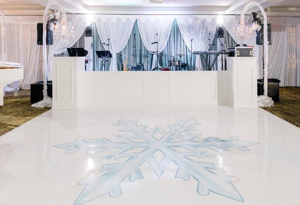 White dance floor adorned with a large blue snowflake