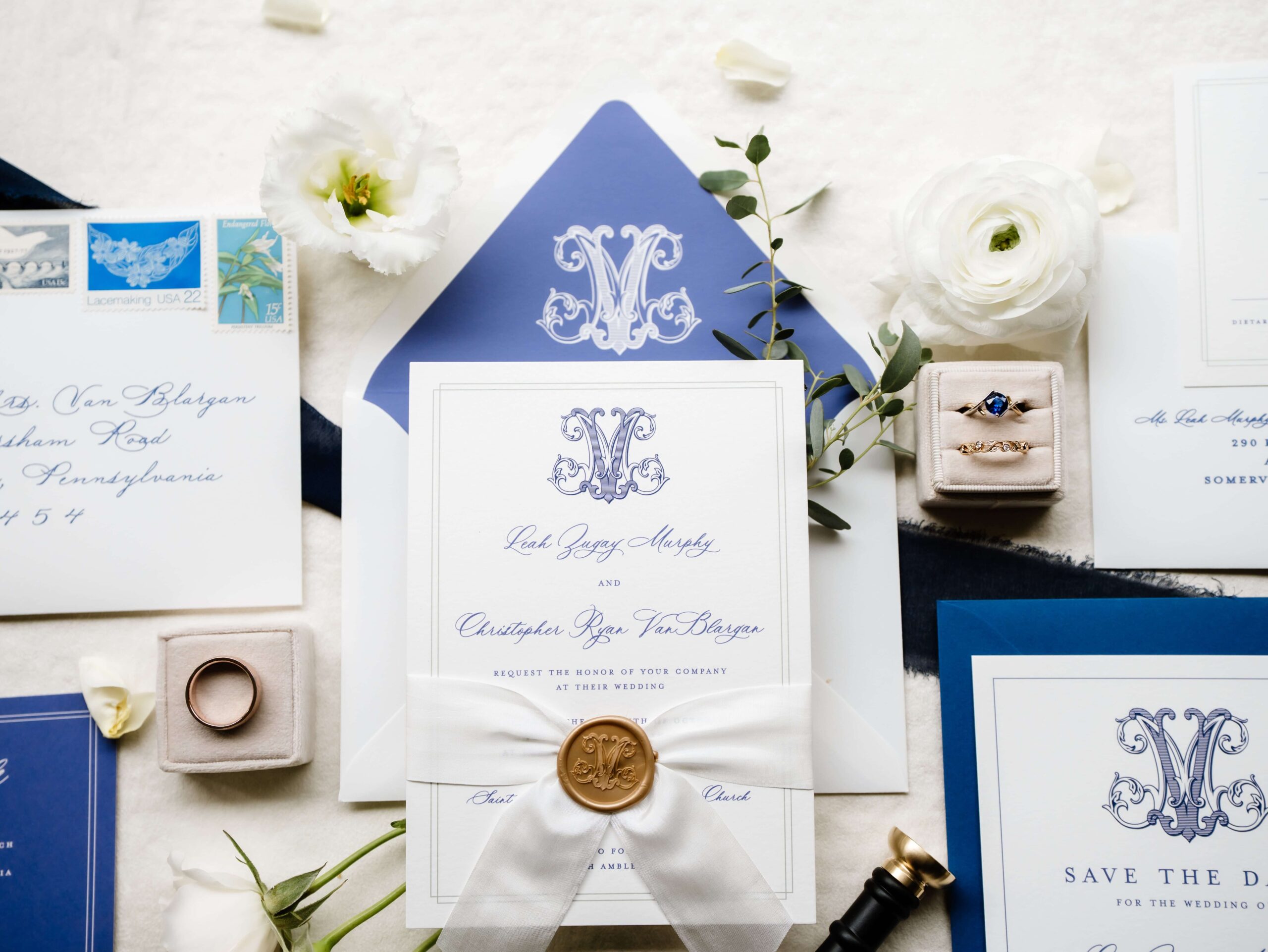 Timeless wedding invitation suite in blue and white with a custom monogram and gold wax seal