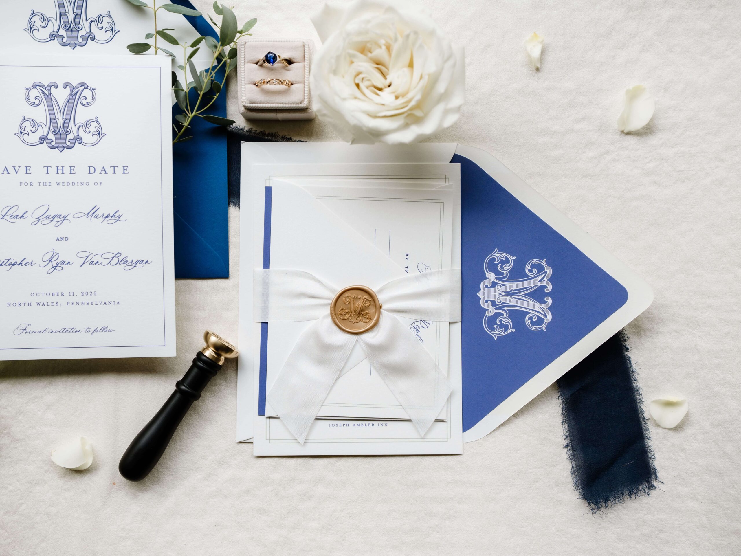 Wedding invitation suite sealed with white silk ribbon and custom monogrammed gold wax seal