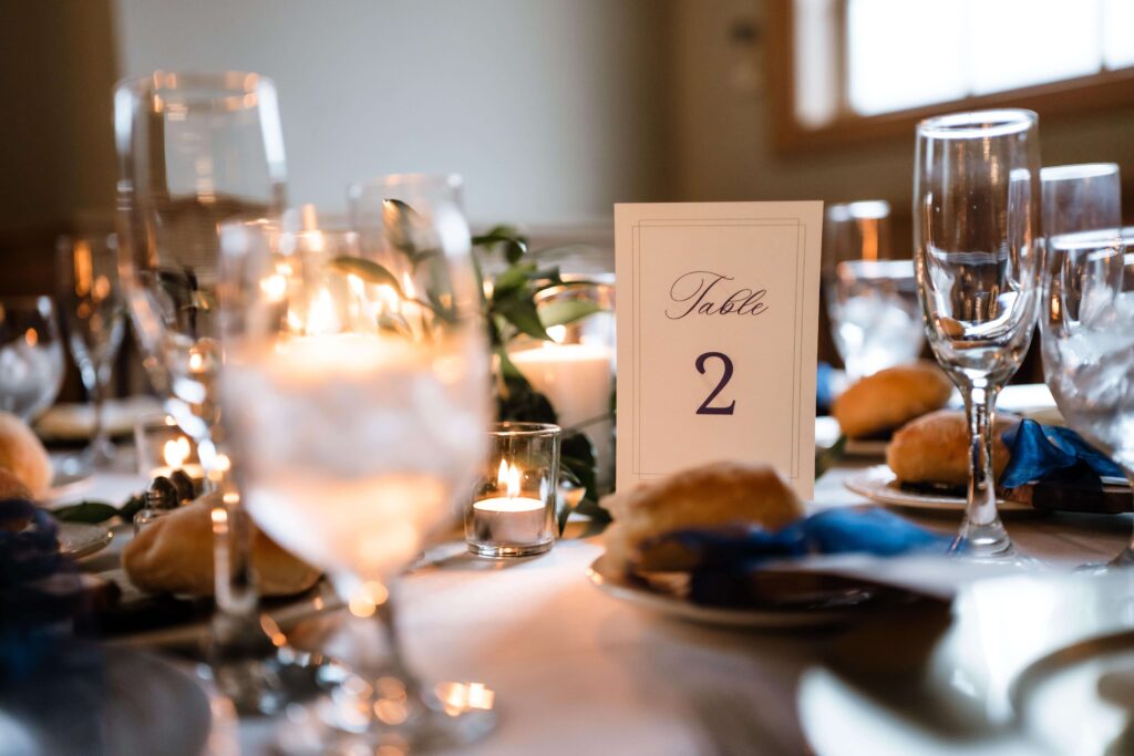 Wedding reception table with table number 2 in elegant blue script font