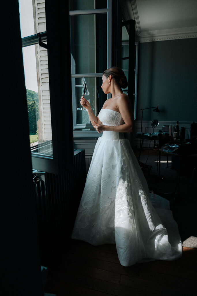 Bride examining makeup on her wedding day