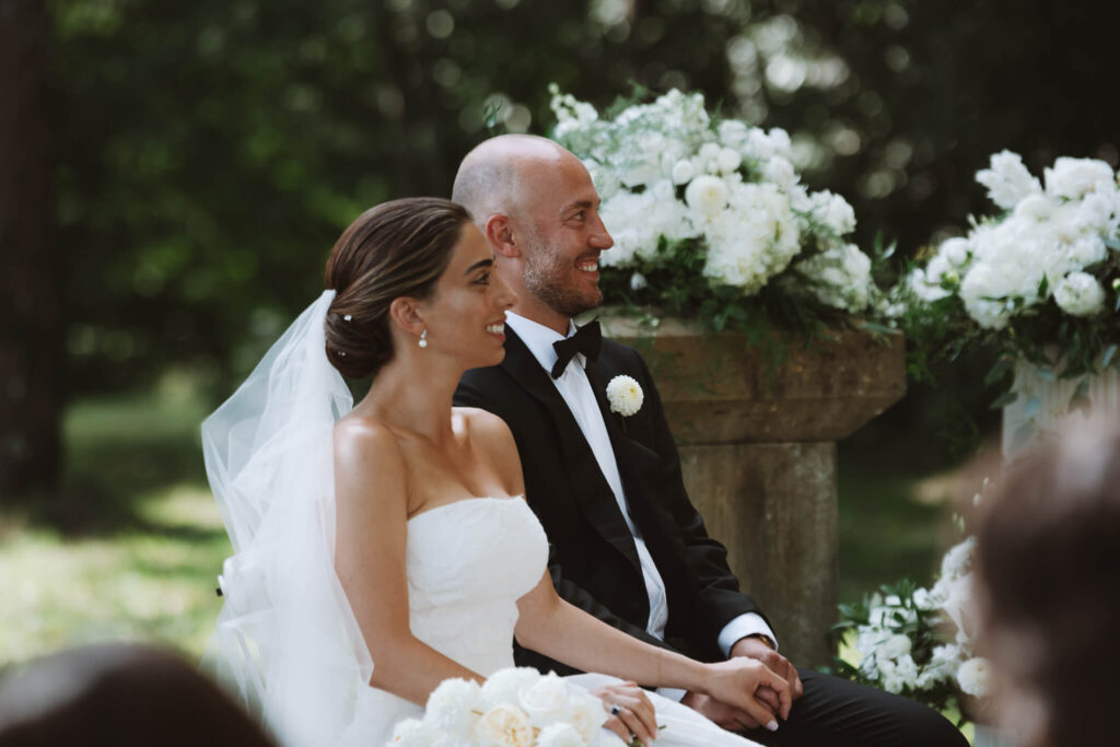 Bride and groom smiling and holding hands during their wedding ceremony