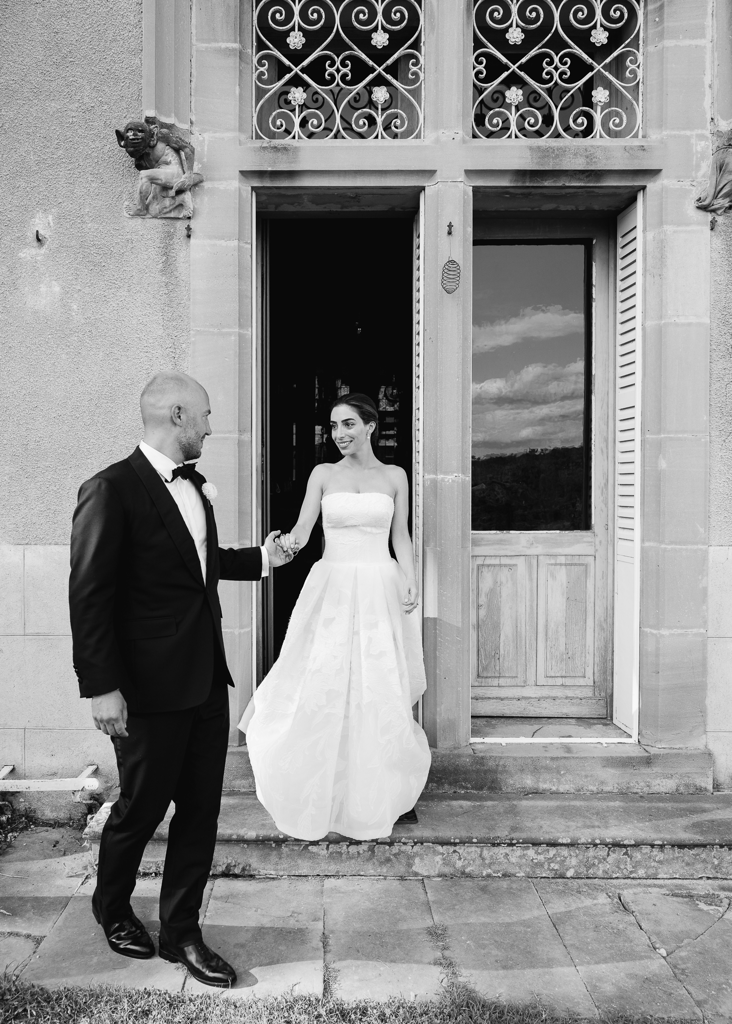 Bride and groom candid on the doorstep of a French château