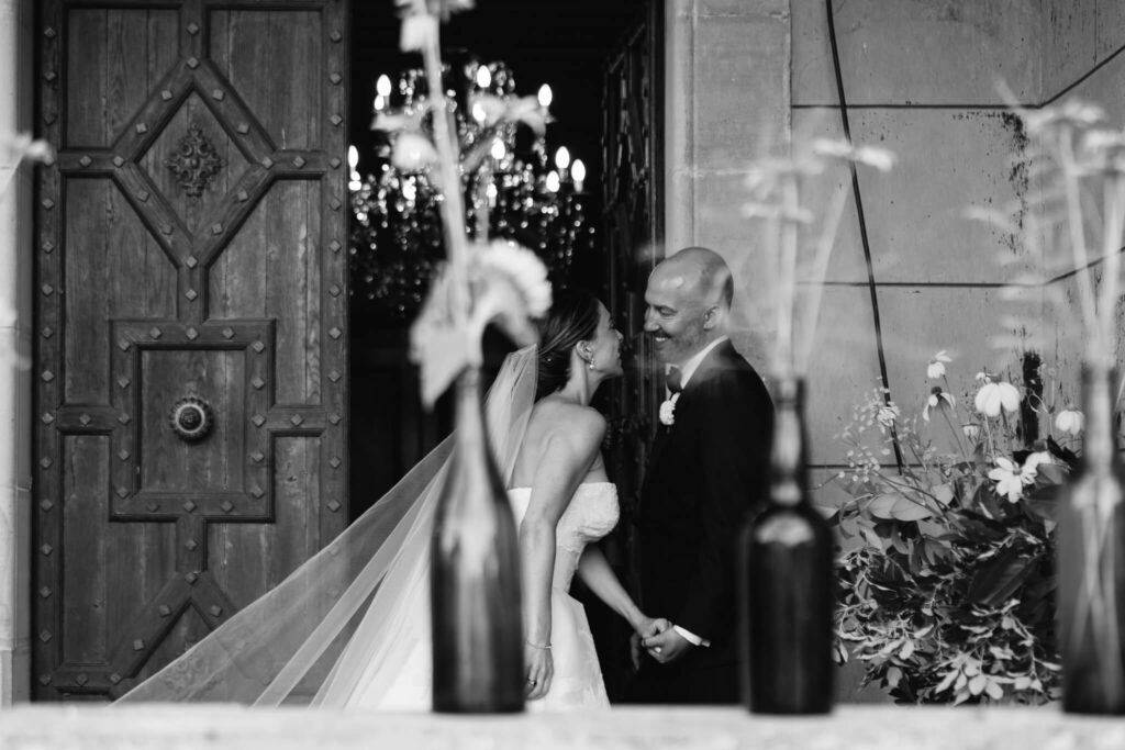 Bride and groom laugh on the patio of Château de Sibra