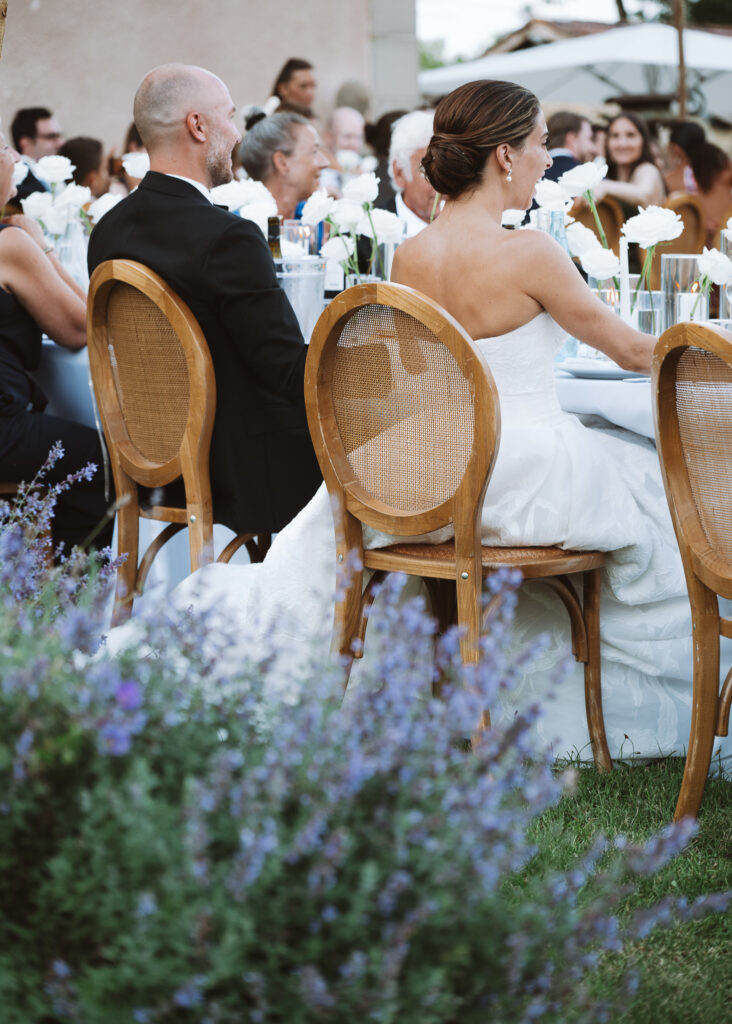 Bride and groom during wedding reception at head table