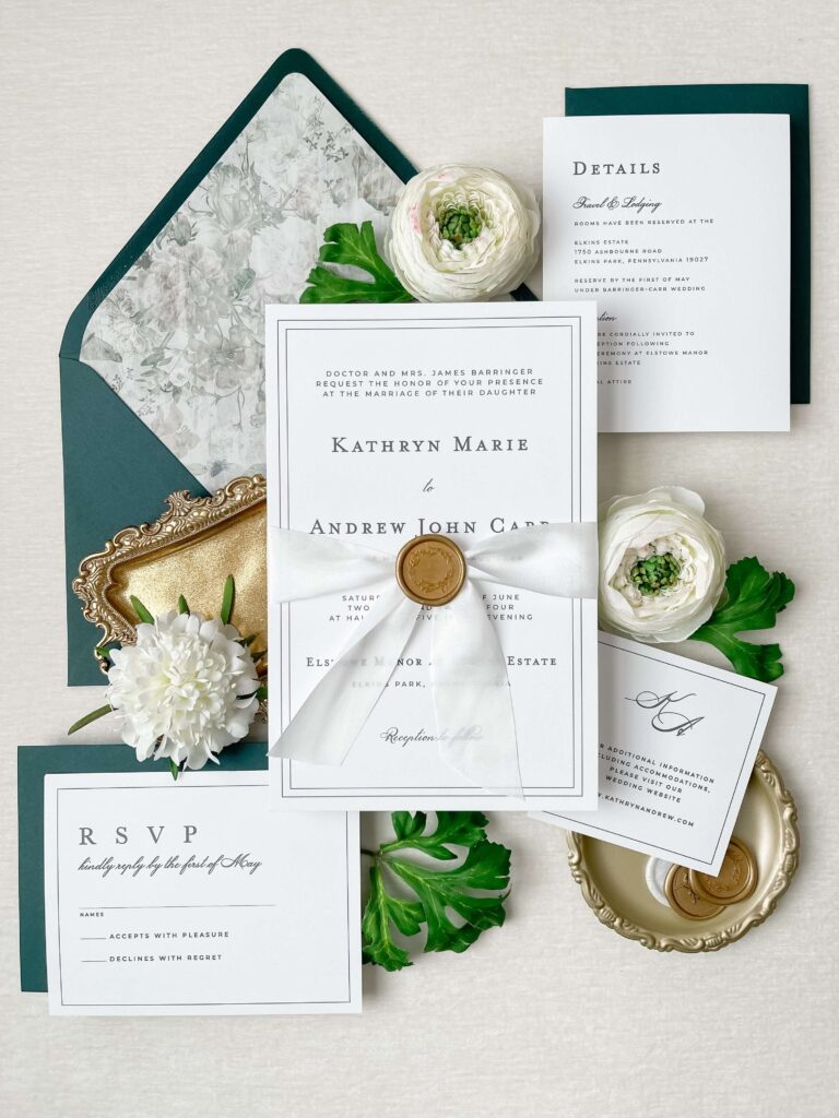 Formal wedding invitation suite in black and white with a dark green envelope and fine art envelope liner