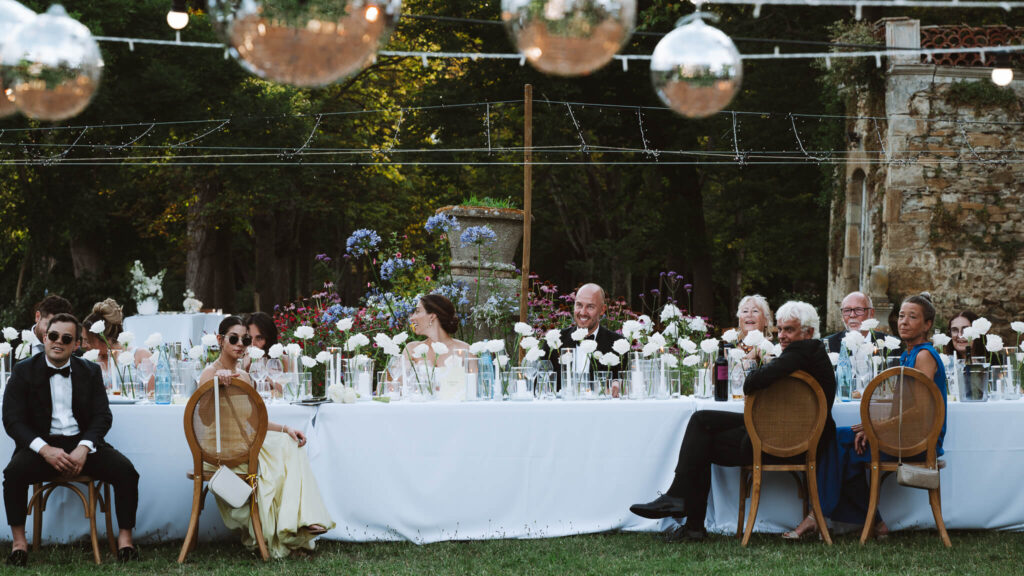 Bride and groom and long wedding head table during their reception