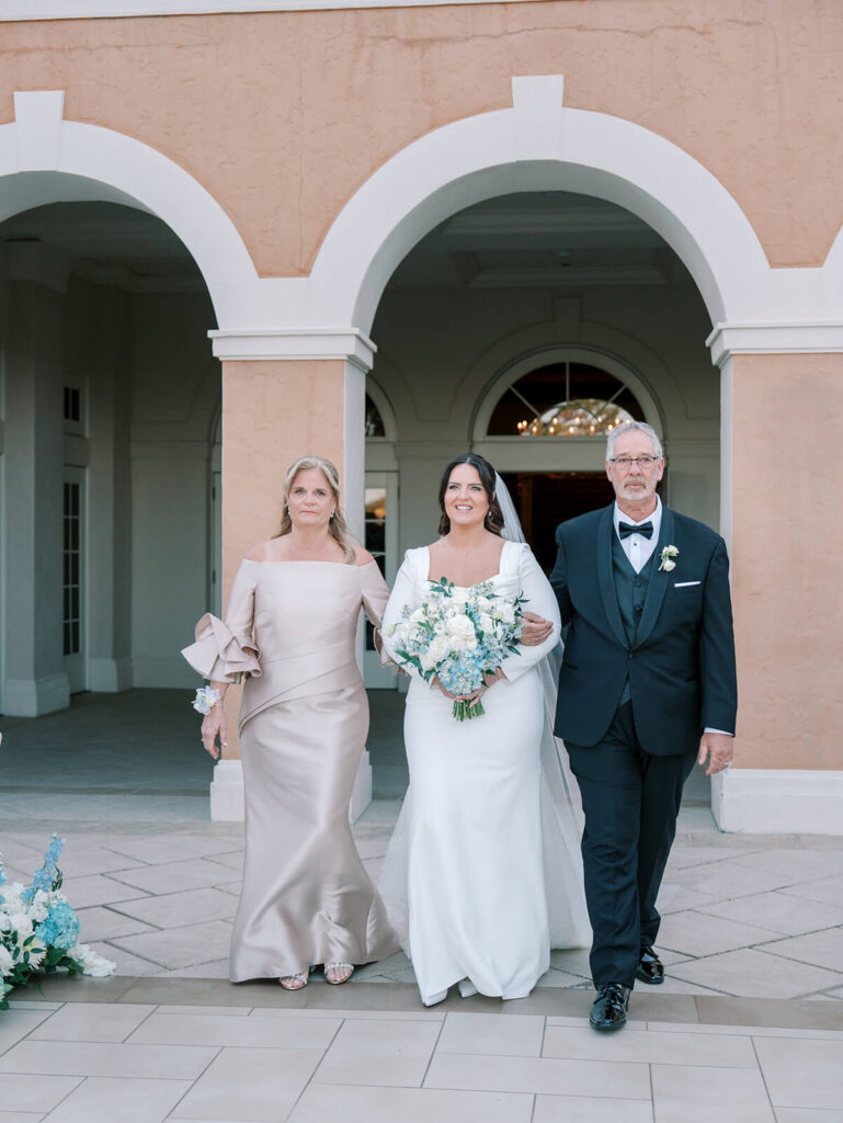 Bride escorted down aisle by parents