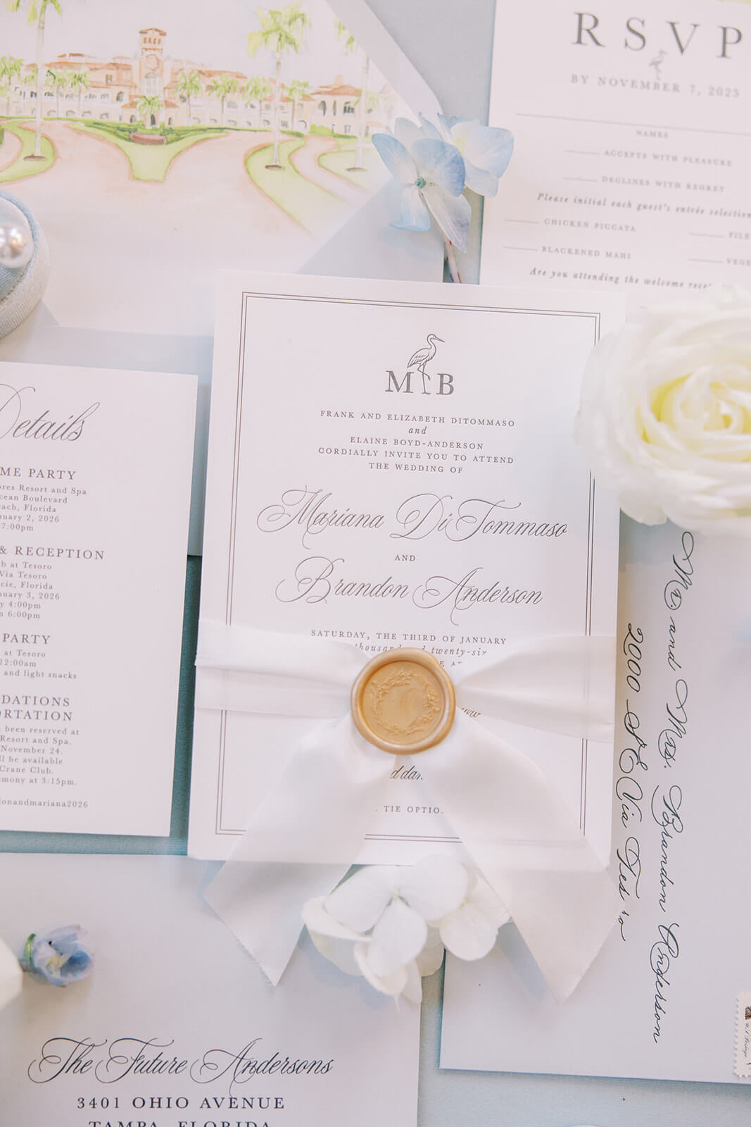Classic wedding invitation card with custom monogram, silk ribbon, and gold wax seal