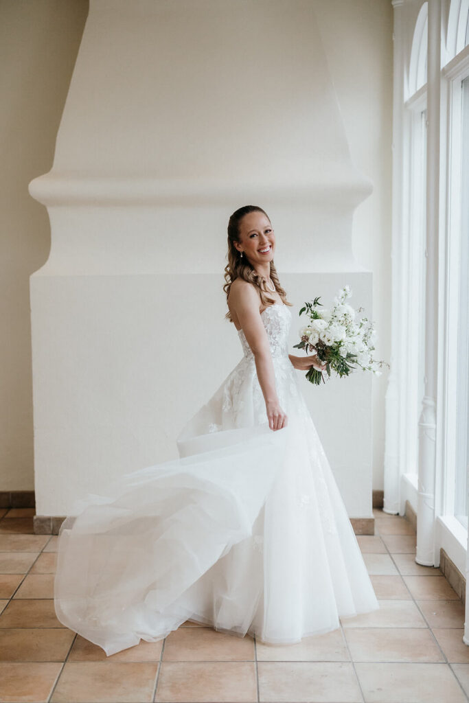 Portrait of the bride holding a white and green bouquet