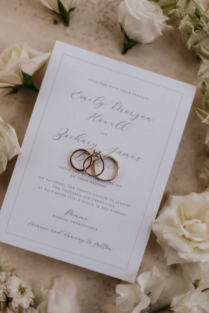 Wedding rings on a simple and elegant wedding invitation card