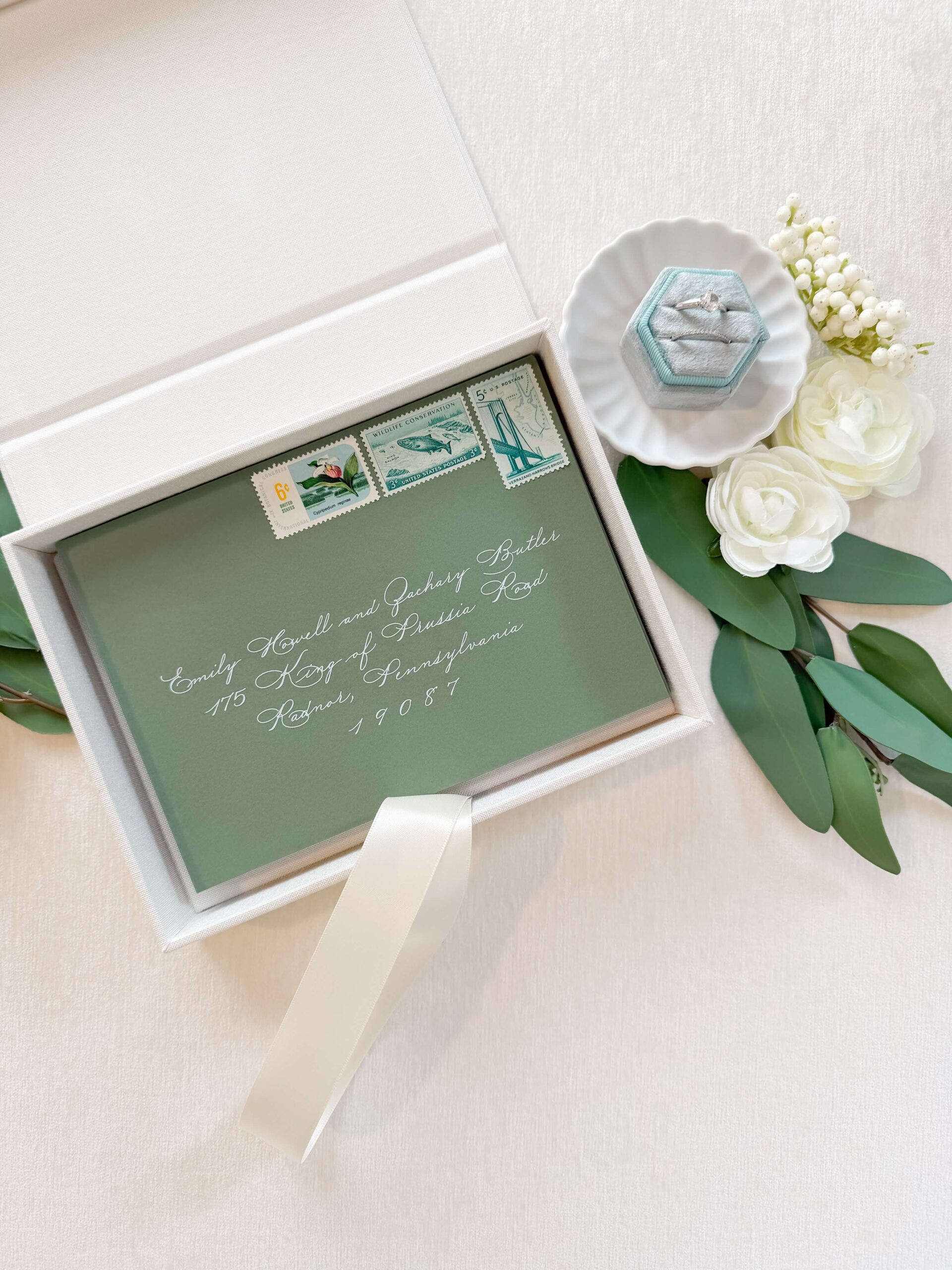 Linen box displaying a keepsake invitation suite that custom stationery clients receive