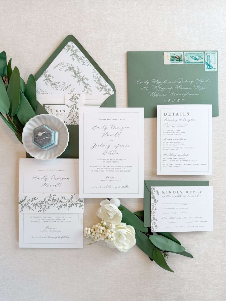 Nature-inspired wedding invitation suite with greenery details