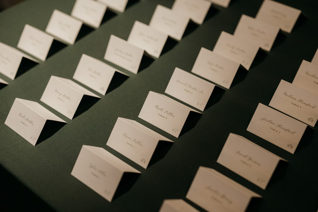Tented wedding escort cards with guest meal choice displayed