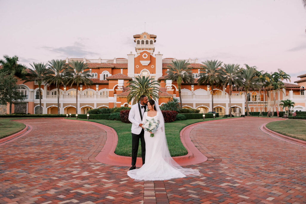 Elegant portrait of bride and groom in front of Crane Club at Tesoro wedding venue