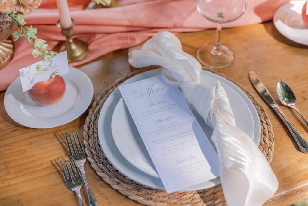 Woven charger with an elegant wedding menu card and linen napkin