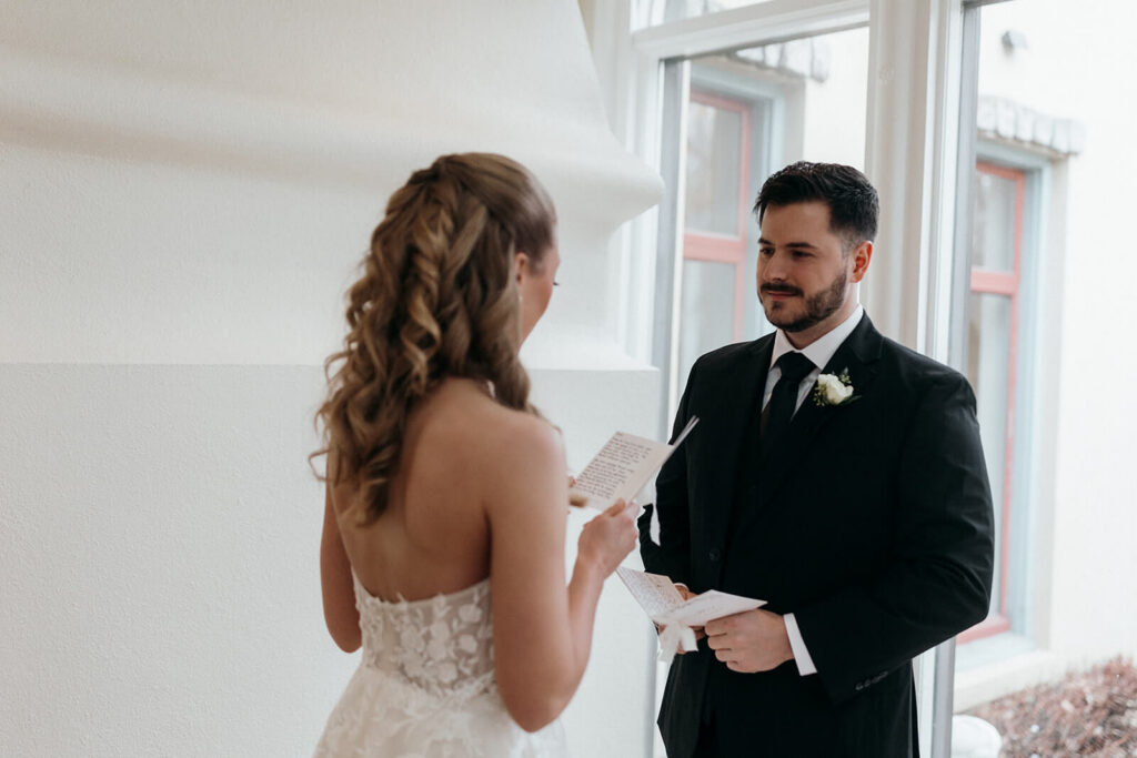 Bride and groom read vows in private