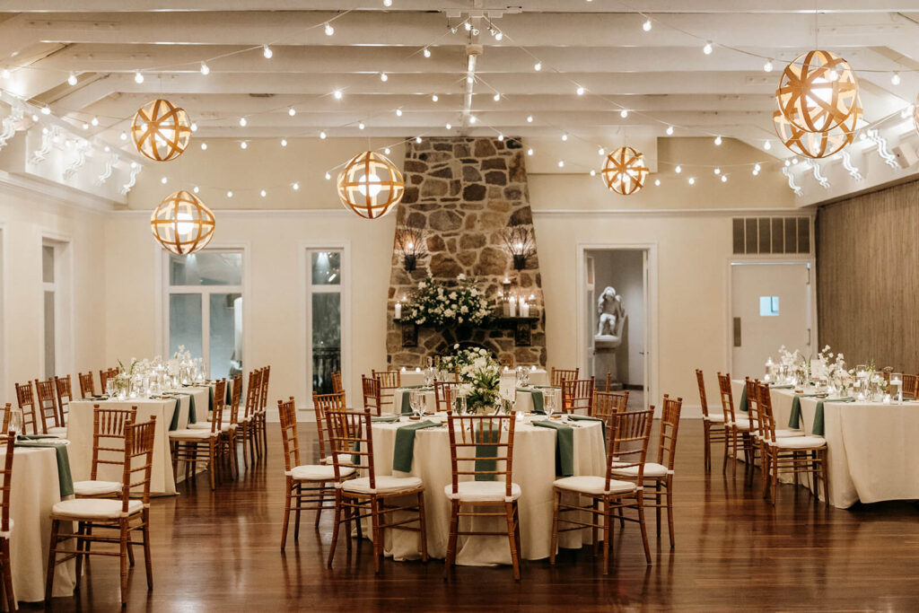 Elegant white and green theme indoor wedding reception at Pomme Radnor