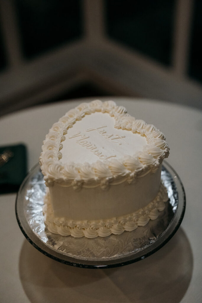 Single-tier heart shaped wedding cake that says "Just Married"