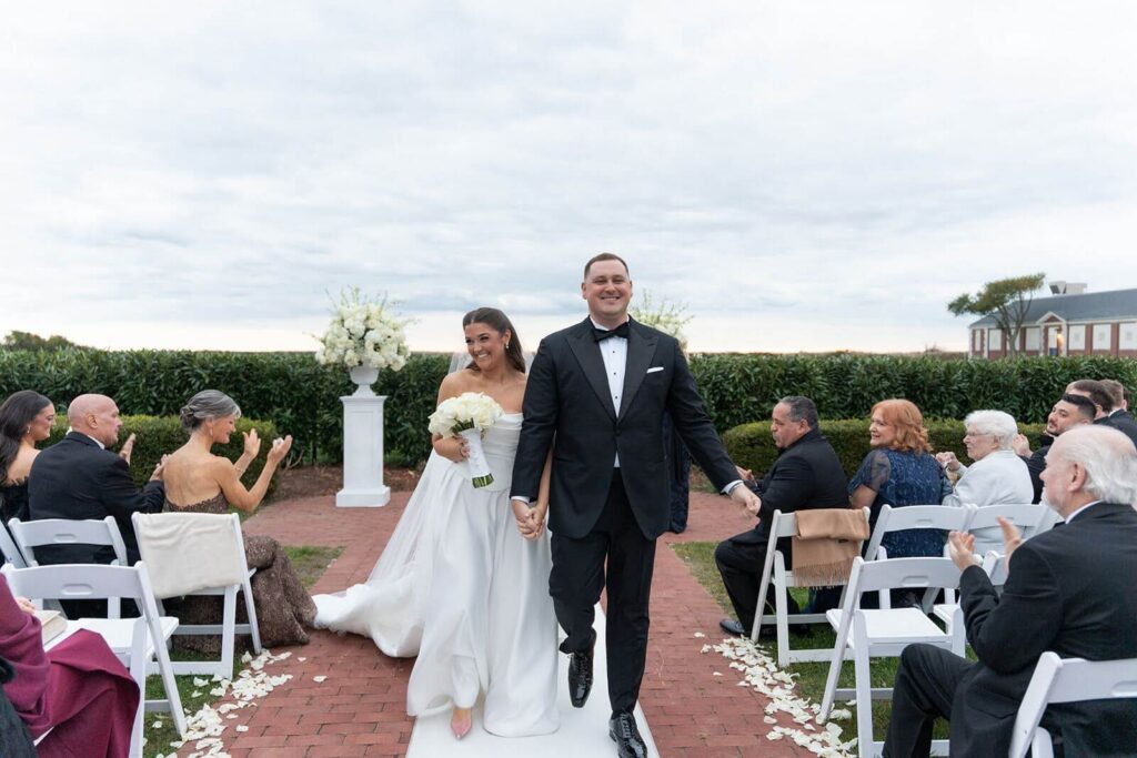 Bride and groom, just married, exiting their wedding ceremony