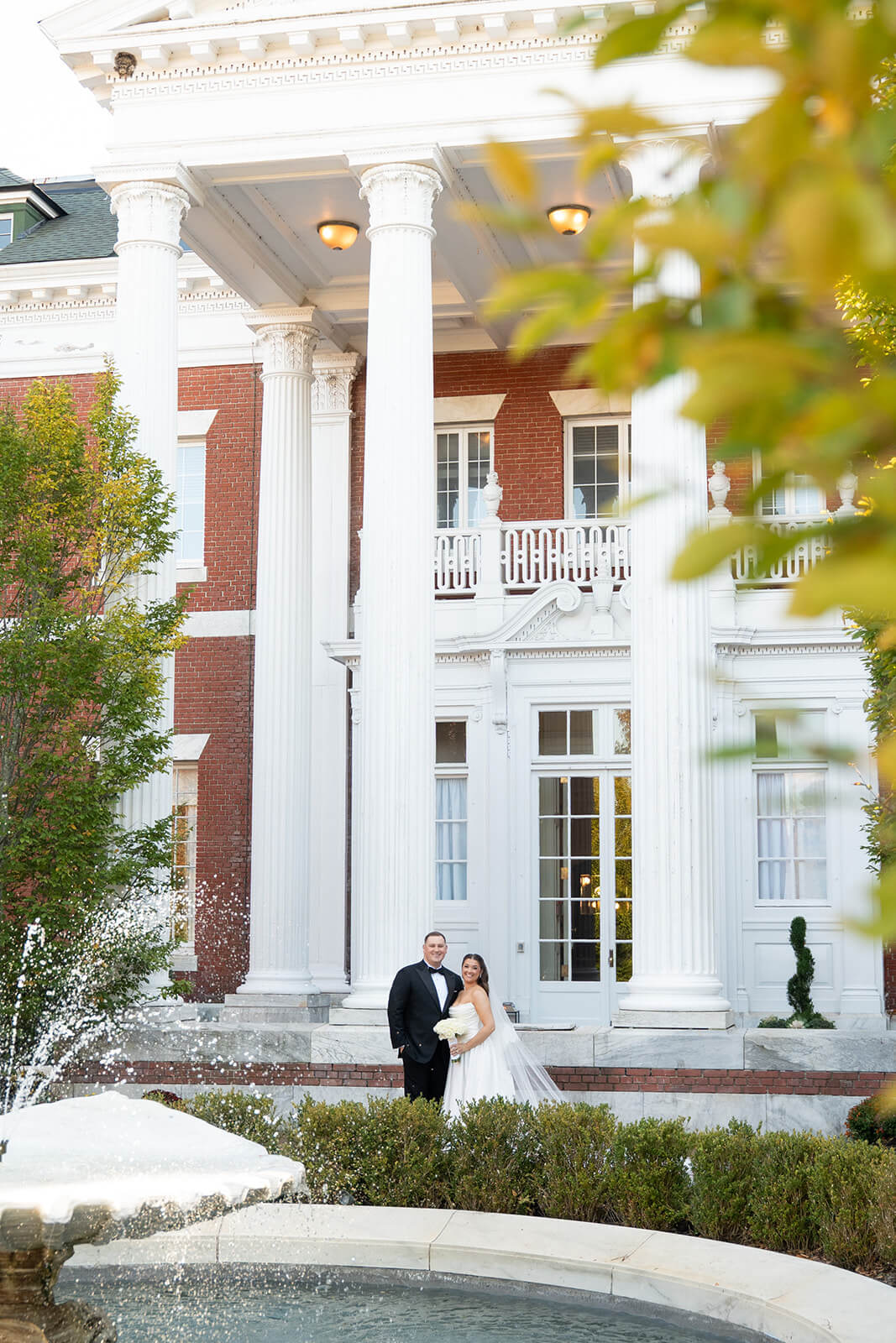 Portrait of the bride and groom on on their wedding day at Bourne Mansion