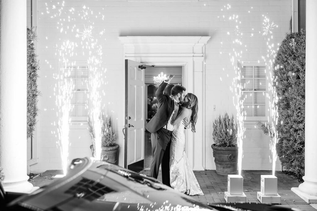 Bride and groom kissing during their cold sparks exit