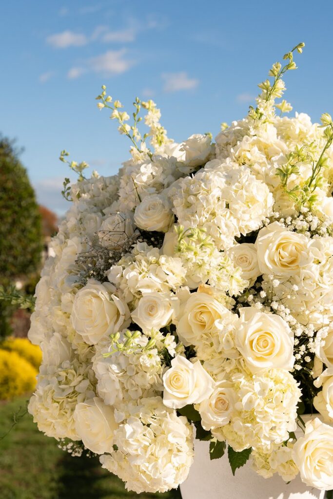 Classic white floral arrangement with roses and hydrangeas