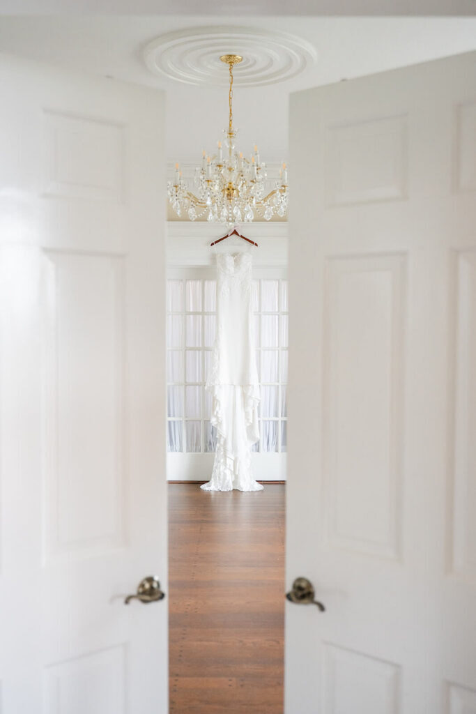 Bride's dress hanging in an elegant room at Adams Estate