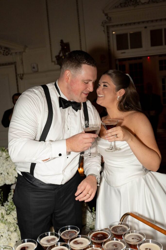 Bride and groom clinking their espresso martini glasses