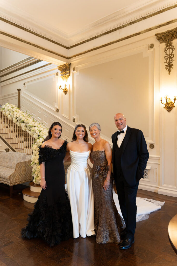 Elegant family portrait for a black tie wedding at Bourne Mansion