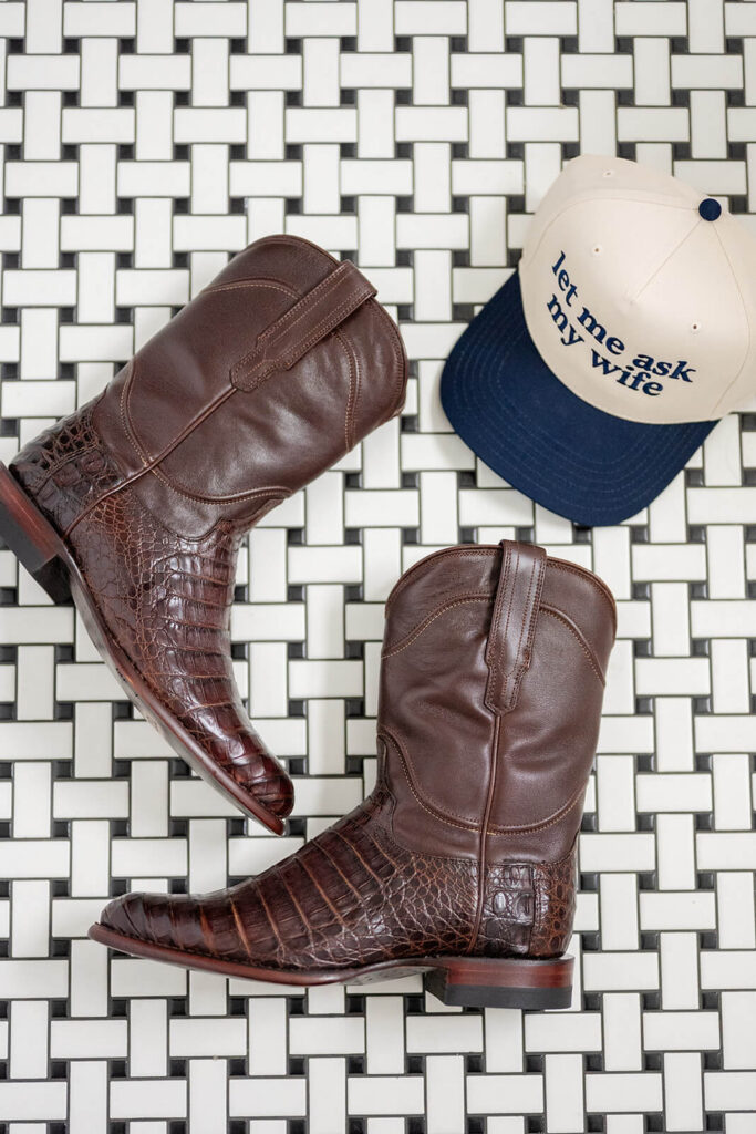 Details shot of groom's presents: custom hat and Tecovas